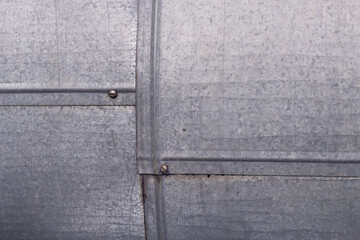 Galvanized iron construction with close up. Grey metallic surface with connected squares.