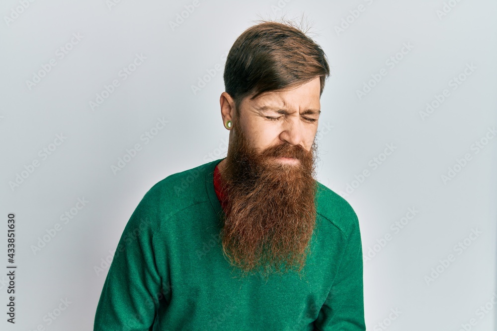 Sticker redhead man with long beard wearing casual clothes with hand on stomach because indigestion, painful