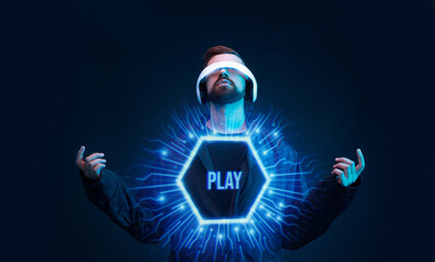 Man on dark virtual reality background. Guy using VR helmet. Augmented reality, future technology, game concept. Blue neon light. Futuristic holographic interface to display data.