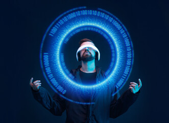 Man on dark virtual reality background. Guy using VR helmet. Augmented reality, future technology, game concept. Blue neon light. Futuristic holographic interface to display data.