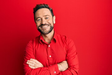 Middle age man wearing casual clothes happy face smiling with crossed arms looking at the camera. positive person.