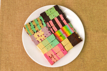 Malaysian traditional food called as Kek Lapis Sarawak or Sarawak Layered Cake on white plate. Similar cake in Indonesia also known as Kek Lapis Legit or Legit Layered Cake