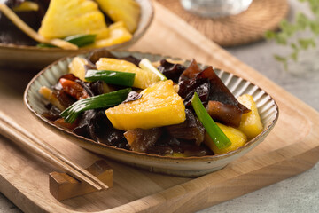 Stir-fried pineapple with black wood ear fungus.