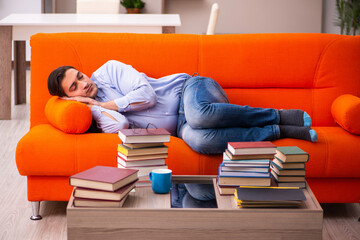 Young male student preparing for exams at home