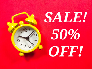 Text SALE 50 OFF with alarm clock on red background.