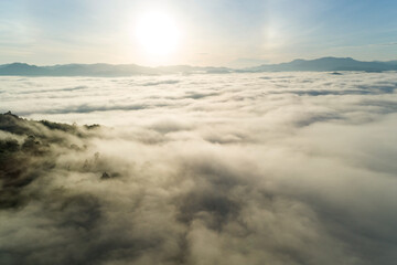 Amazing Landscape light nature scenery view, Beautiful light sunrise or sunset over Tropical sea and foggy mist on mountains peak in thailand Aerial view Drone camera shot High angle view