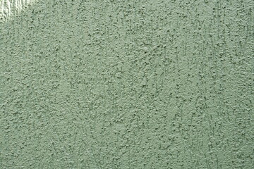 Green wall texture with reliefs. Closeup. Green background.