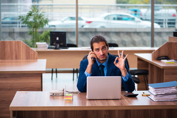 Young male employee working in the office