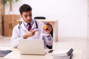 Young male doctor cardiologist working in the clinic