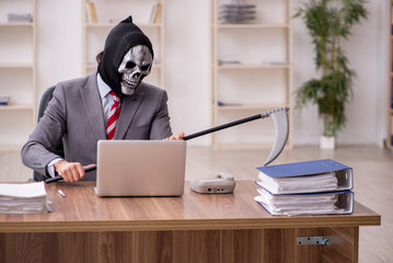 Devil businessman employee sitting at workplace