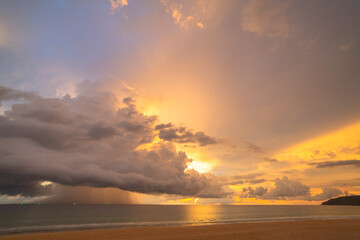 rain cloud at sunset over sea water. Evening landscape with sun over sea water..panorama rain cloud and dramatic twilight sky and cloud sunset background..Nature image High quality footage.