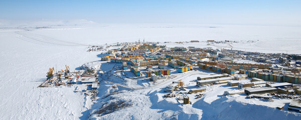 Winter aerial view of a northern port town in the Arctic. Panorama of a snow-covered coastal city. Anadyr is the administrative center of the Chukotka Autonomous Okrug. The easternmost city in Russia.