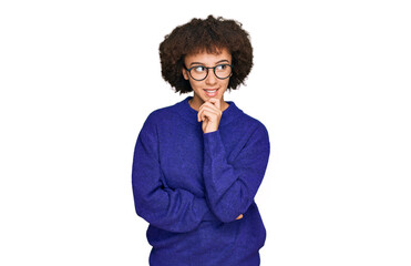 Fototapeta na wymiar Young hispanic girl wearing casual winter sweater and glasses with hand on chin thinking about question, pensive expression. smiling with thoughtful face. doubt concept.