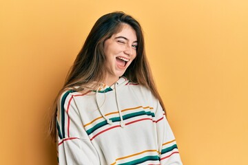 Young caucasian woman wearing casual clothes winking looking at the camera with sexy expression,...