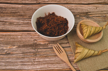 Malay traditional food called as Ketupat rice or Ketupat Palas with serunding. Glutinous rice is wrapped with banana leaf and served during Eid Mubarak