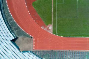 Papier Peint photo autocollant Chemin de fer Aerial view of empty green football field with running track, Running track with number in top view