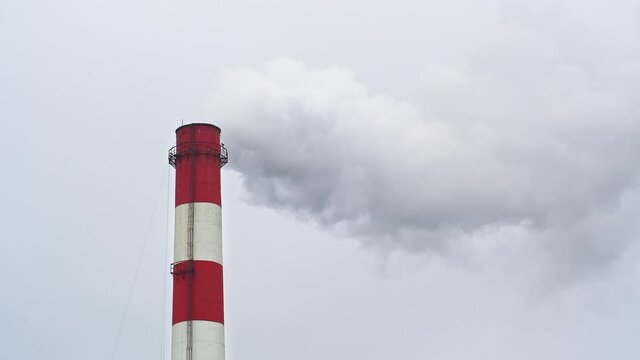 Top of an industrial chimney with smoke coming from it, copy space