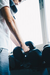 Smart sport man lifting dumbbell up in fitness gym wellnes activity - obrazy, fototapety, plakaty