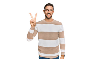 Handsome man with beard wearing casual clothes and glasses showing and pointing up with fingers number two while smiling confident and happy.
