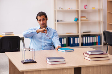 Fototapeta premium Young male teacher in the classroom