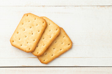 Cracker cookies on white wooden table background.