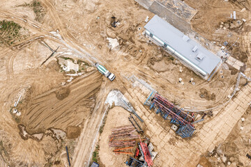aerial top view of storage place at building site with construction materials and equipment....