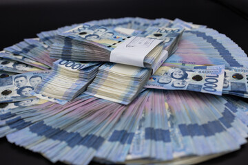 A pile of one thousand Philippines peso banknotes. Cash of Thousand dollar bills, Peso background...