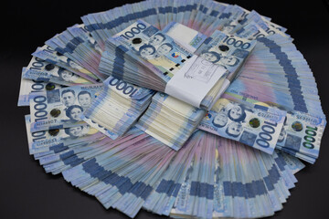 A pile of one thousand Philippines peso banknotes. Cash of Thousand dollar bills, Peso background...