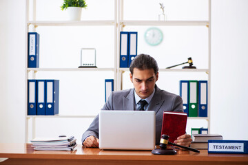Fototapeta premium Young male lawyer sitting in the office