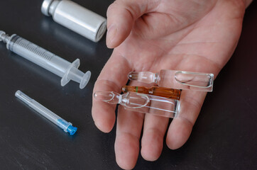 Arm, Syringe, three ampoules and a bottle of white powder