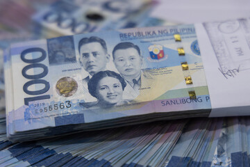 A pile of one thousand Philippines peso banknotes. Cash of Thousand dollar bills, Peso background image.