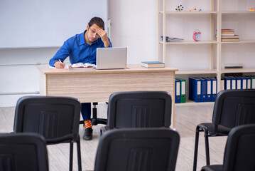 Young male business trainer making presentation during pandemic