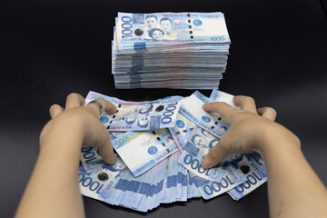 A pile of one thousand Philippines peso banknotes. Cash of Thousand dollar bills, Peso background...