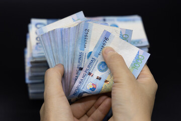 A pile of one thousand Philippines peso banknotes. Cash of Thousand dollar bills, Peso background...