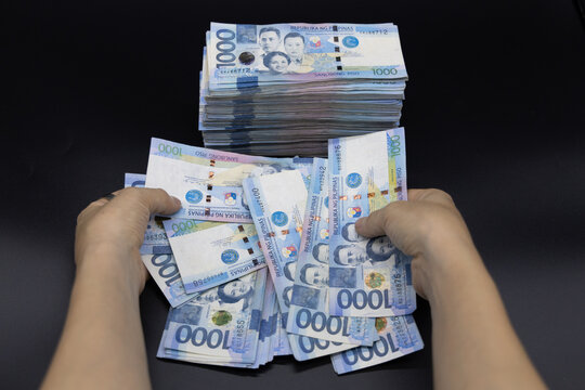 A pile of one thousand Philippines peso banknotes. Cash of Thousand dollar bills, Peso background image.