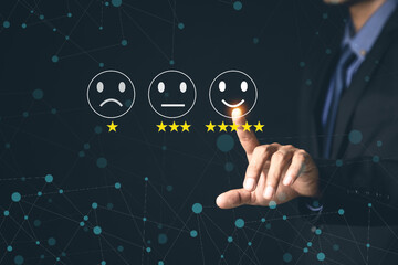 Customer Service and Satisfaction Concept Businessmen touch the virtual screen on happy smiley icons to achieve service satisfaction and feedback with excellent rated reviews.