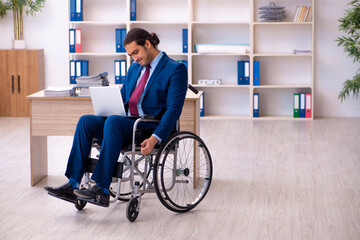 Young disabled employee working in the office