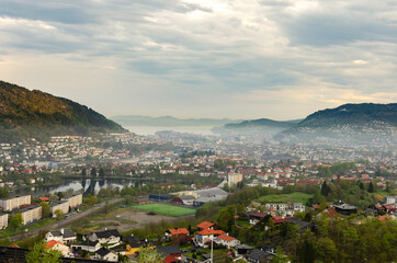 Aerial city view of Bergen, Norway under a blanket of morning fog. 