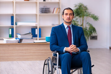 Young disabled employee working in the office