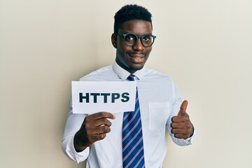 Handsome black man holding https privacy url smiling happy and positive, thumb up doing excellent and approval sign