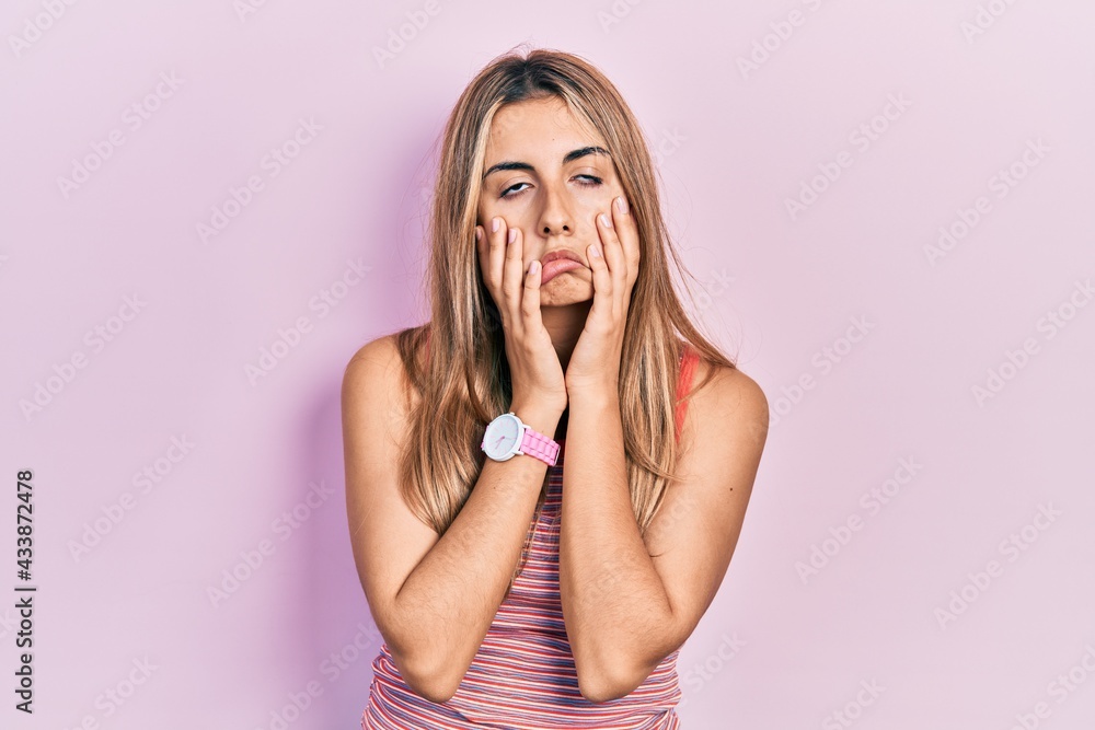 Canvas Prints Beautiful hispanic woman wearing casual summer t shirt tired hands covering face, depression and sadness, upset and irritated for problem