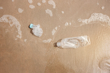 Environment, Ecology Care, Renewable Concept. Plastic Bottle Waste on the Beach Sand. Top View