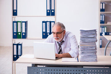 Old male employee unhappy with excessive work in the office