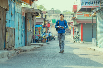 Young photographer taking pictures on the streets of India