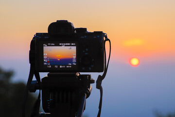 Recording beautiful view of sunset on professional camera