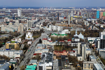 Scenic view of the city from above. Sunny weather, blue clouds. Urban landscape