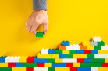 hand stacking up the plastic block