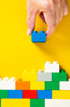 Hand Stacking Up The Plastic Block