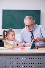 Old teacher and schoolgirl in the school