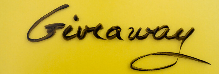 Giveaway handwritten on textured glass, on illuminating yellow background, banner